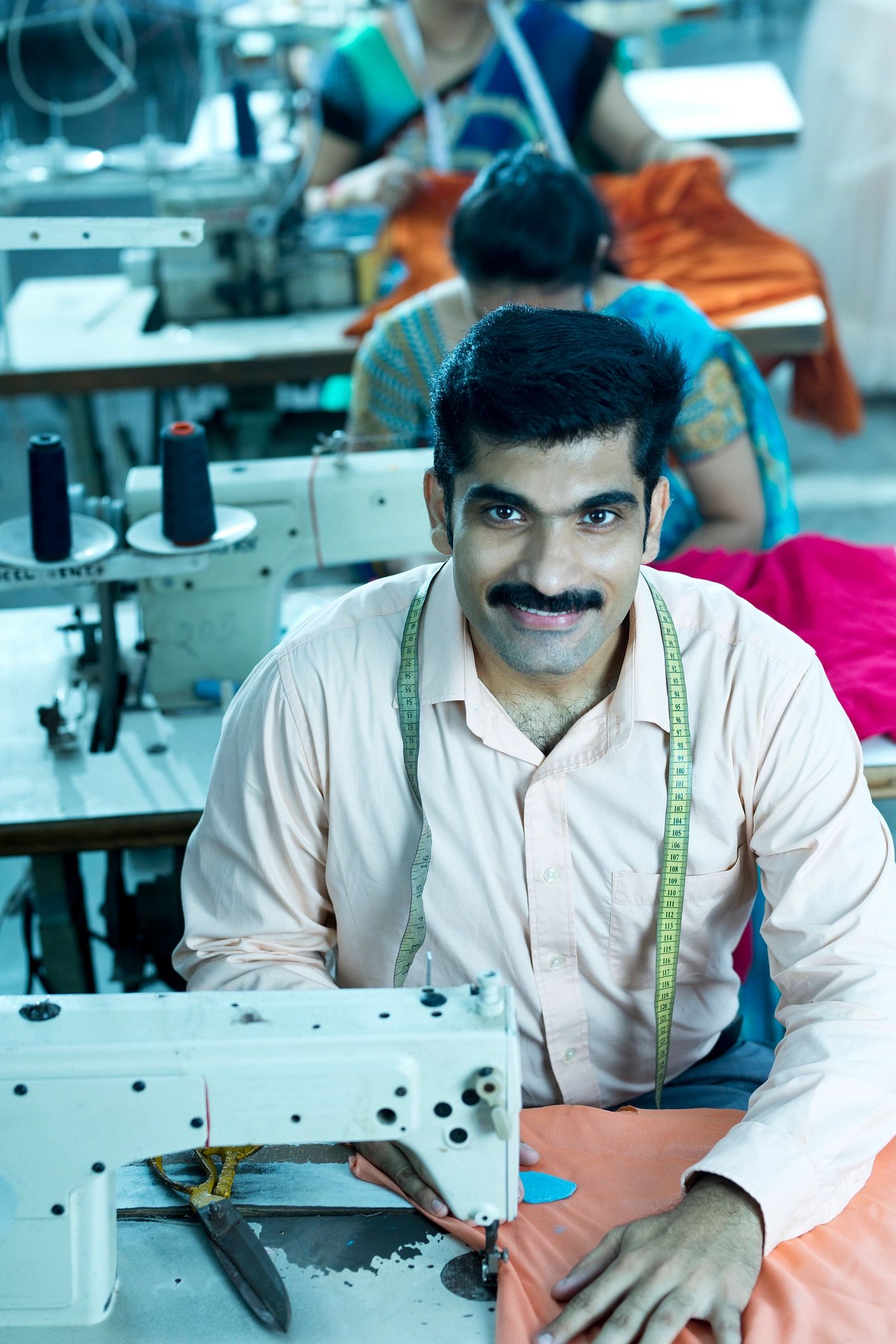 Textile worker using a sewing machine in a factory