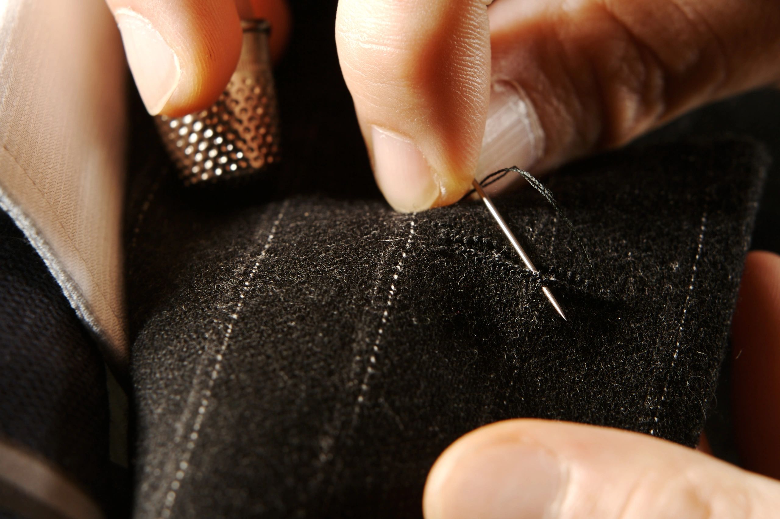 Tailor at work on handcrafted textile details