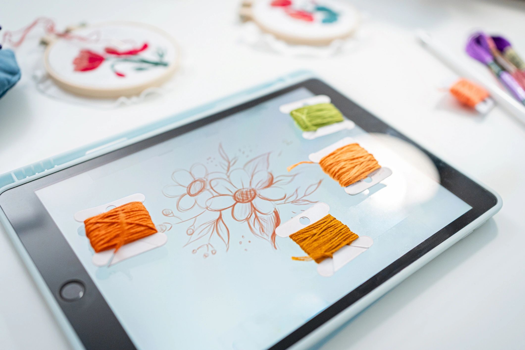 Designer creating embroidery artwork on a tablet