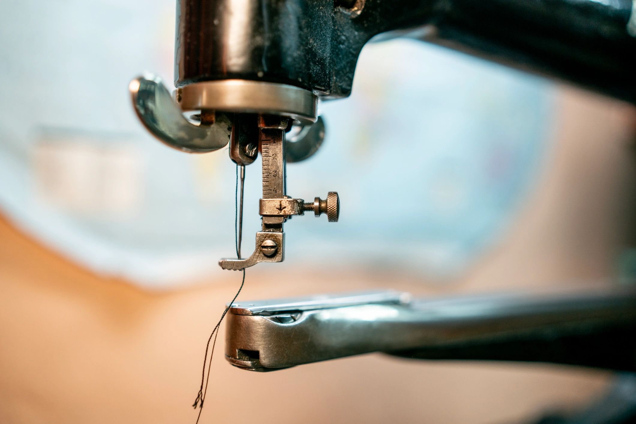 Close-up of sewing machine needle and thread